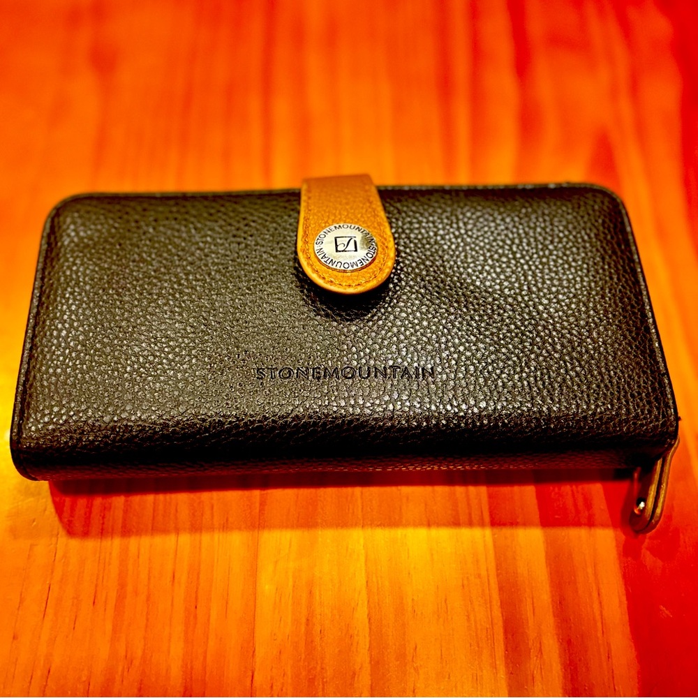 A Stone Mountain Ludlow large zip around wallet with a pebble leather